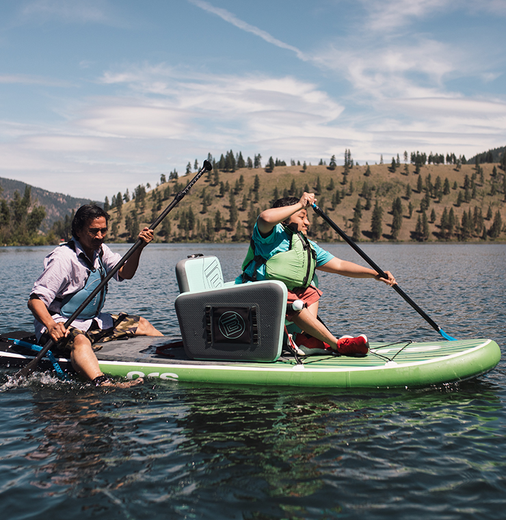 Canuck Place recreation therapy activity with a family paddle boarding on a lake