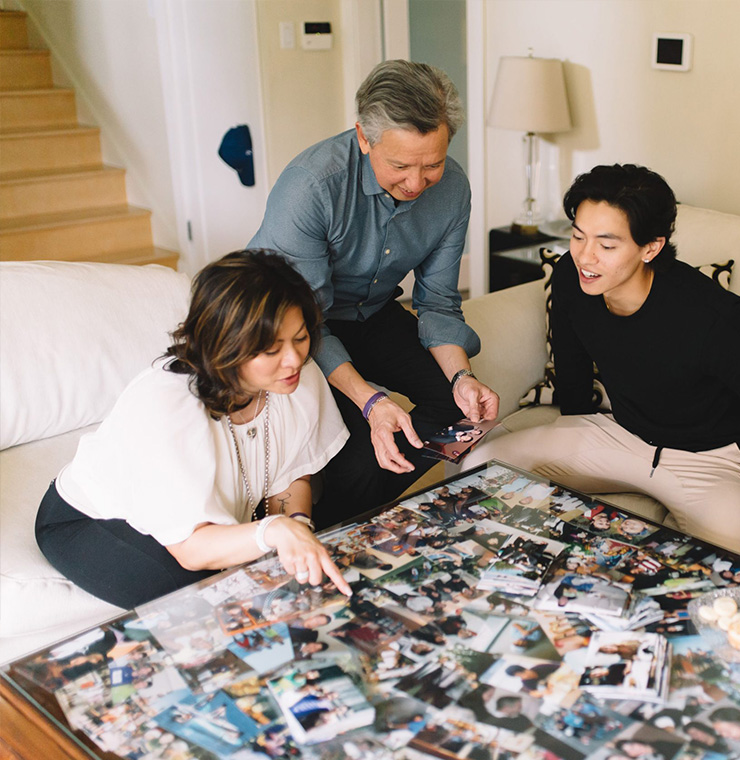 family looking at images on table together