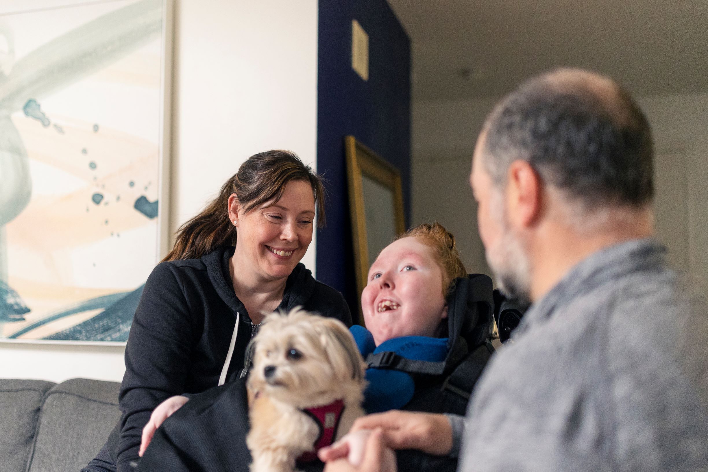 Canuck Place child, Charlie-Anne, with her mom Cherie, stepdad Drew and dog, Izzy