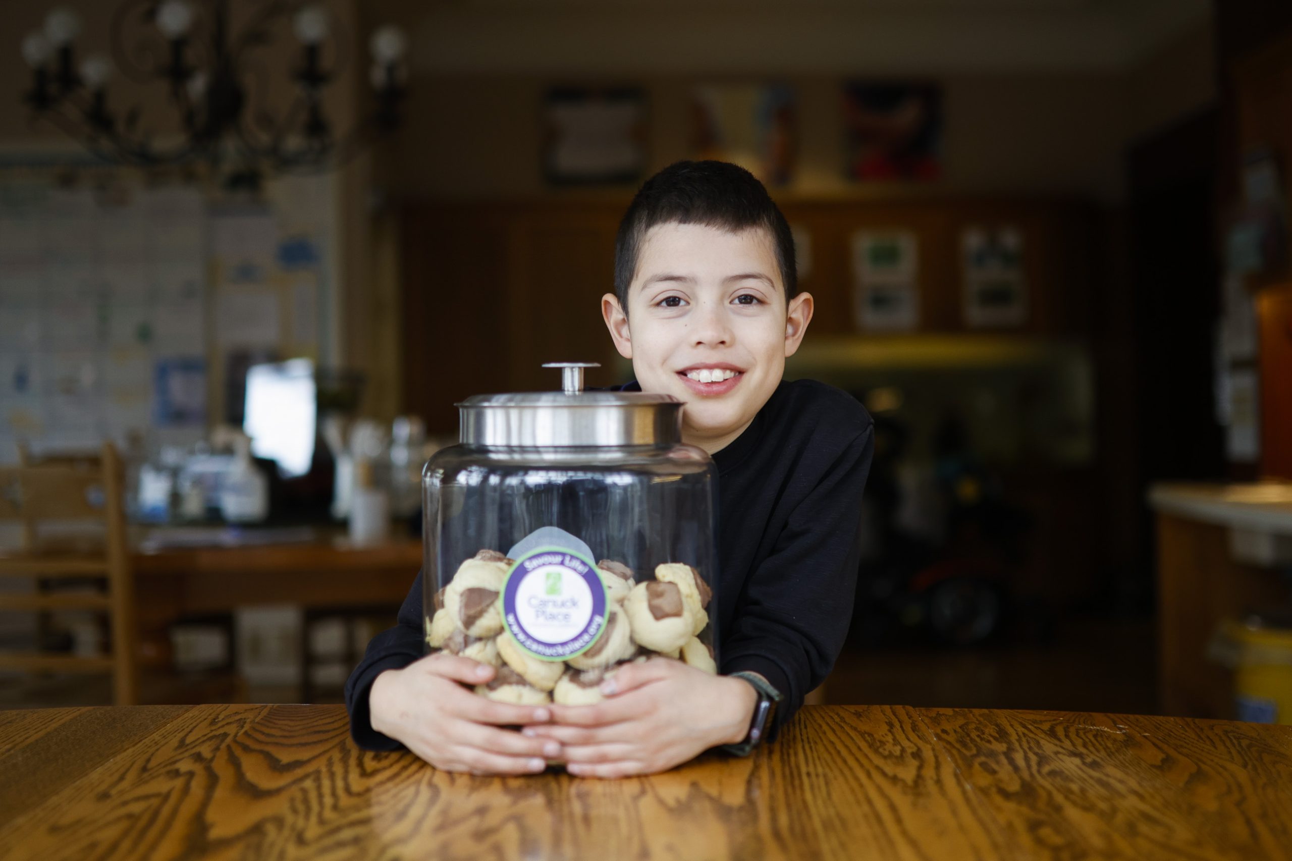 Canuck Place sibling, Jero with Canuck Place cookies