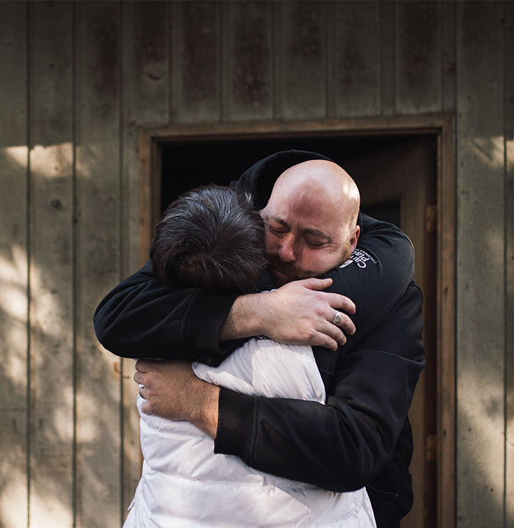 Nick, Canuck Place father, embracing Nurse Practitioner