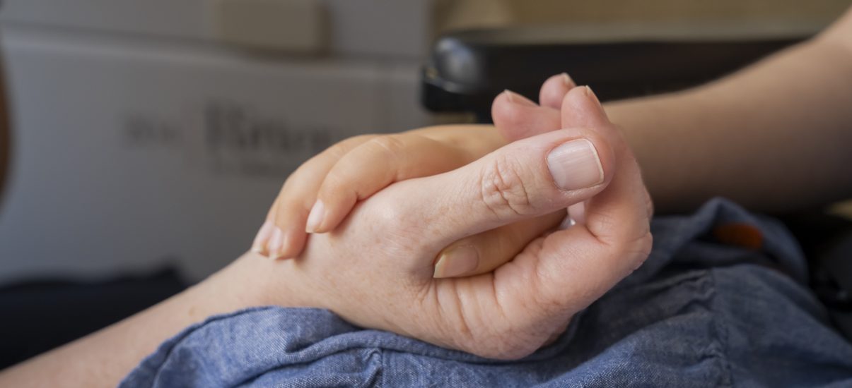 Close up of a nurse holding a child's hand