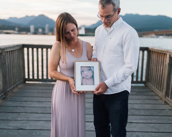 Canuck Place parents holding photo of their baby