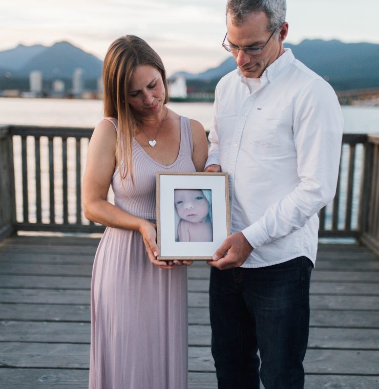 Canuck Place parents holding photo of their baby