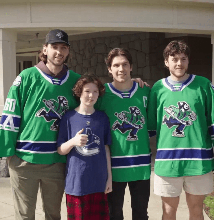 Nikita Tolopilo, Chase Wouters, and Cole McWard with Canuck Place Sibling, Liam Woods